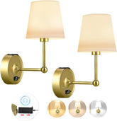 Two gold wall sconces with beige lampshades on a white background.